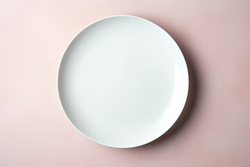 Fototapeta premium top view of an empty white plate on pink background
