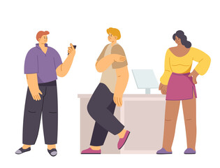 People standing by reception desk looking at phone