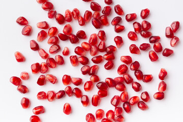 Pomegranate grains on white isolated top view