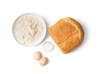 Homemade bread cooked in a bread machine and ingredients for baking on a white background, top view.