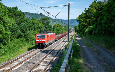 Naklejka premium a train of the Deutsche Bundesbahn drives through the German green landscape
