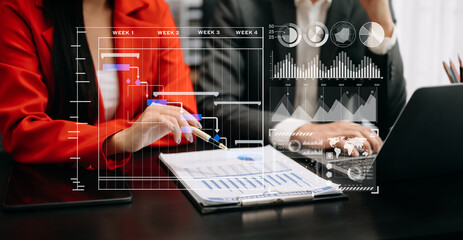 Business team hand Project manager working and update tasks and Gantt chart scheduling virtual diagram.with smart phone, tablet and laptop