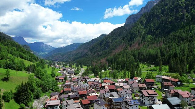 Picturesque village of Sottoguda in a valley in sunny day, Italy. Aerial rising
