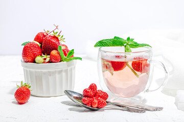 Strawberry tea concept. Good morning concept. Teapot, ripe fruits, healthy beverage