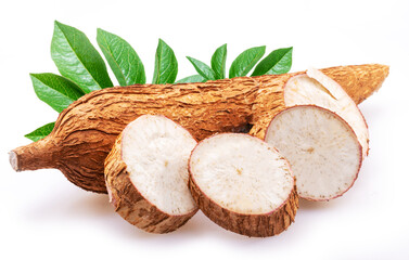 Cassava tubers with leaves and cassava slices isolated on white background.