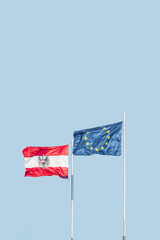 Cover page with two flags of EU and Austria standing in wind together at blue sky solid background with copy space