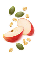 Red apple pieces, green pumpkin seeds and rolled oats isolated on white background. Cereal ingredients