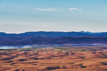 beautiful view on a moroccan village, lake and mountains in the background 