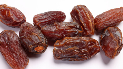 Dry ripe sweet date fruit on white background