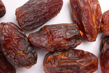 Dry ripe sweet date fruit on white background