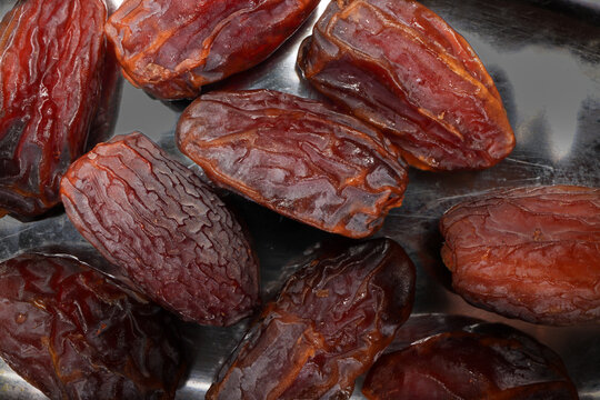 Dry ripe sweet date fruit on white background