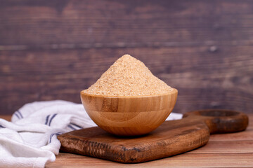 Breadcrumbs on wood background. Breadcrumbs flour in wooden bowl