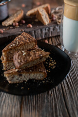 Slices of nut chocolate cake on wooden rustic background