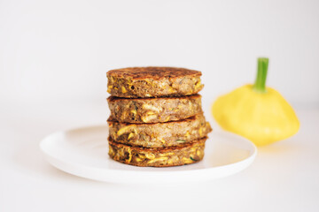 Delicious freshly cooked gluten free thick zucchini pancakes made with natural ingridients such as banana flour, eggs and summer squash. Healthy food with no gluten. Shallow depth of field.