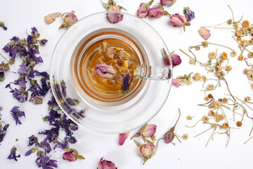 Dry flower tea rose bud butterfly pea chamomile flower transparent ceramic glass tea cup on white background