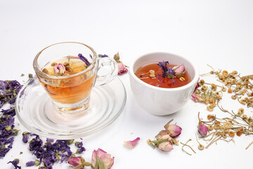 Dry flower tea rose bud butterfly pea chamomile flower transparent ceramic glass tea cup on white background