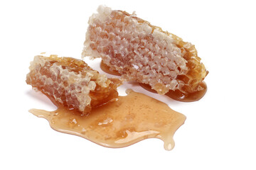 Sticky liquid honey natural geomatic hexagon honeycomb macro closeup on white background