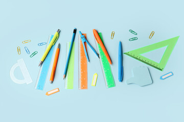Composition with stationery supplies on blue background
