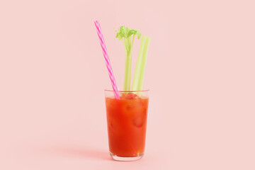 Glass of bloody mary with celery on pink background