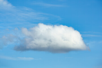 Naklejka na ściany i meble Single white cloud in blue sky