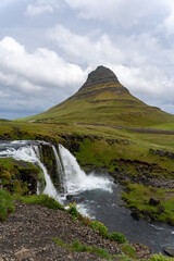 Fototapeta na wymiar Kirkjufell Mountain and Kirkjufellsfoss waterfall in Iceland