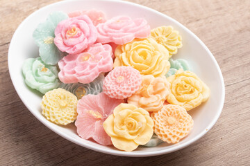 A-lua or Allure Thai handmade candy in a mini bowl on gray desktop. A-lua Thai dessert. Copy space.