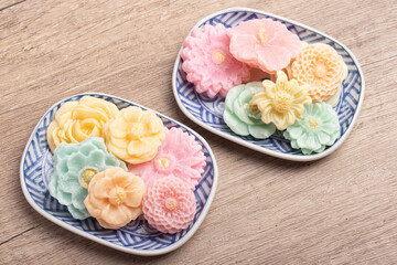 A-lua or Allure Thai handmade candy in a mini bowl on gray desktop. A-lua Thai dessert. Copy space.