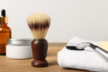 Set of men's shaving tools on wooden table