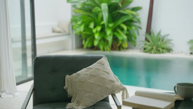 Rain falls in a tropical luxury villa with swimming pool in Bali. Close up