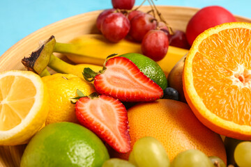 Bowl with different fresh fruits, closeup