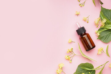 Obraz na płótnie Canvas Bottle of essential oil and fresh linden flowers on pink background