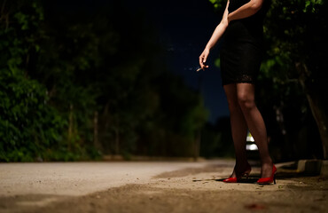 Female prostitute with cigarette on the street.
