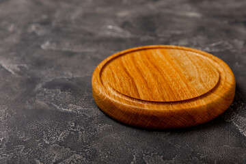 Cutting board on a textured table. Pizza board. Kitchen wooden cutting board and kitchen towel. Kitchenware. Menu. Recipe. The concept of cooking. Mockup