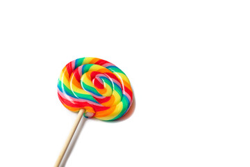 Big round swirl rainbow lollipop isolated on white background. Idea of fun and childhood. Sweet unhealthy food. Space for text.