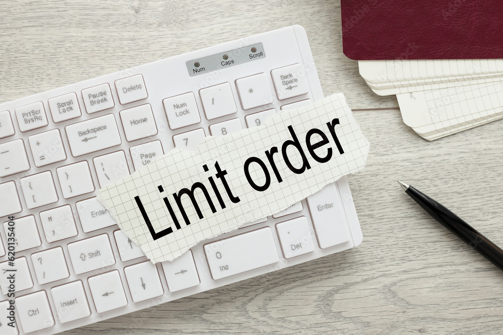 Poster limit order text on torn paper on white keyboard