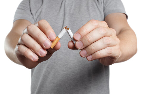 Male hands breaking a cigarette in half, cut out