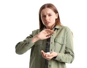 Young female junkie rejecting drugs on white background