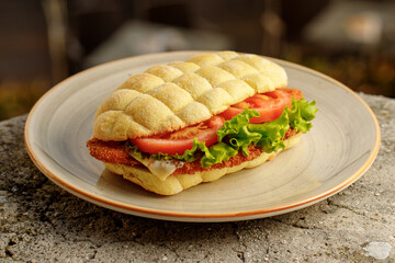 Sandwich made with corn flour with tomatoes, lettuce, chicken schnitzel for restaurant menu