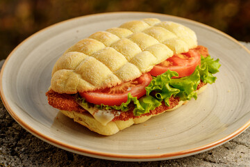 Sandwich made with corn flour with tomatoes, lettuce, chicken schnitzel for restaurant menu