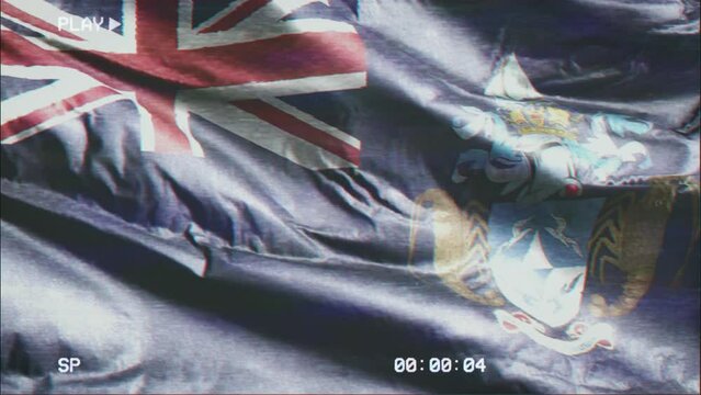 VHS video casette record Tristan Da Cunha flag waving on the wind. Glitch noise with time counter recording banner swaying on the breeze. Seamless loop.