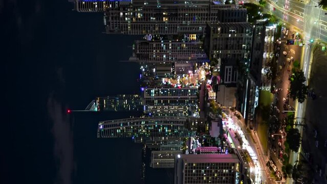 Aerial night hyperlapse over downtown Surfer's Paradise, Gold Coast, Australia, vertical format.