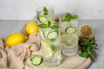 Glasses of mojito with cucumber on tile table