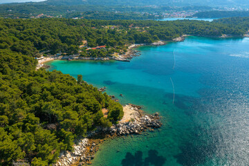 Fototapeta na wymiar Aerial view of the rocky and forested coast of Rab Island, the Adriatic Sea in Croatia