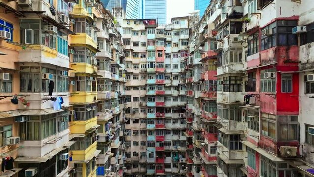 Yick Cheong and Yick Fat old apartment house exterior architecture in Hong Kong city, drone aerial view. Asian people residential life, transformer building or monster building travel landmark
