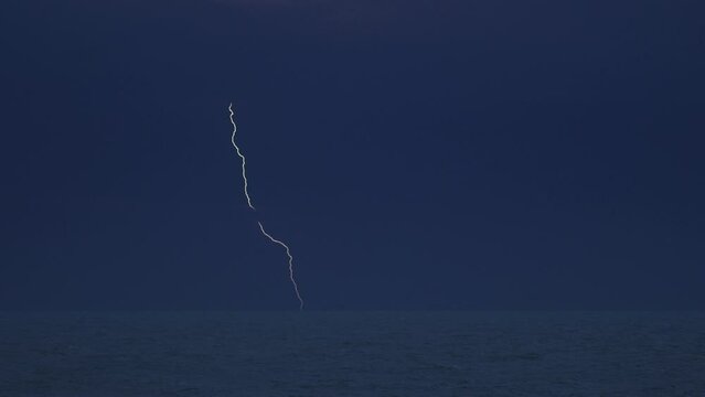 Fork lightning striking the ocean waves Florida coastline 