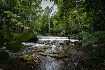 Naklejka premium Small waterfall Nõmmeveski in Estonia on the river Valge.