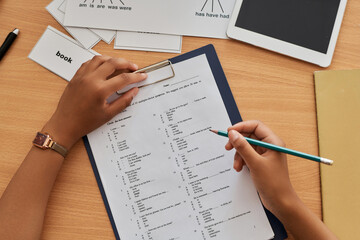 Obraz premium Top view of student writing foreign language test at table