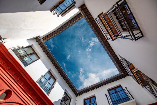One of the inner courtyards of El Palacio de Mondragón, historic Mudejar-Renaissance building located in the old town of Ronda, Malaga, Spain with the sky above