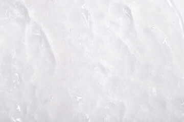 Cosmetic gel, serum transparent sample. Liquid cream with bubble texture. Gel texture of a cosmetic product. Clear liquid lotion for skin care.