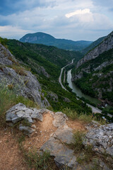 Fototapeta na wymiar Amazing view from the top of the mountain on the Sicevac Gorge near the town of Nis, Balkan Mountains, Serbia. A beautiful winding road passes through the gorge of the river Nisava.